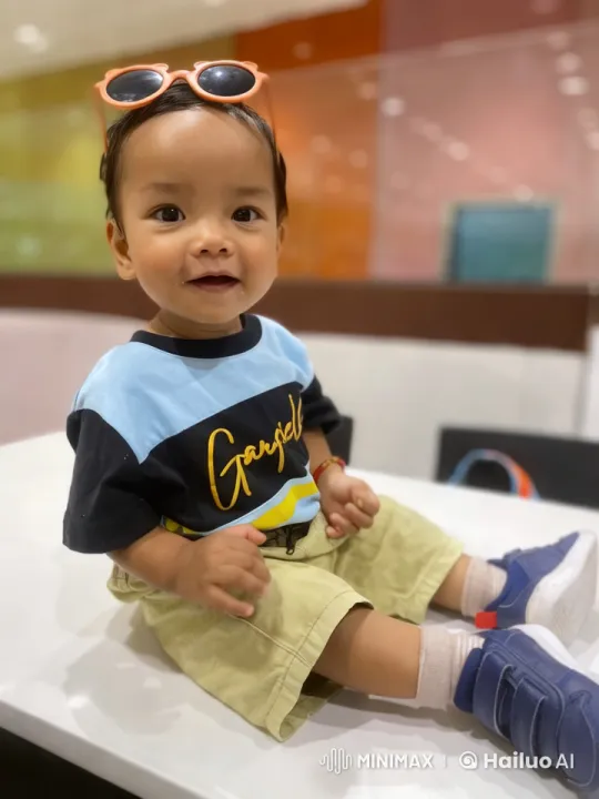 Child Showcases Energy and Style on White Table – AI Generated Video | Hailuo AI