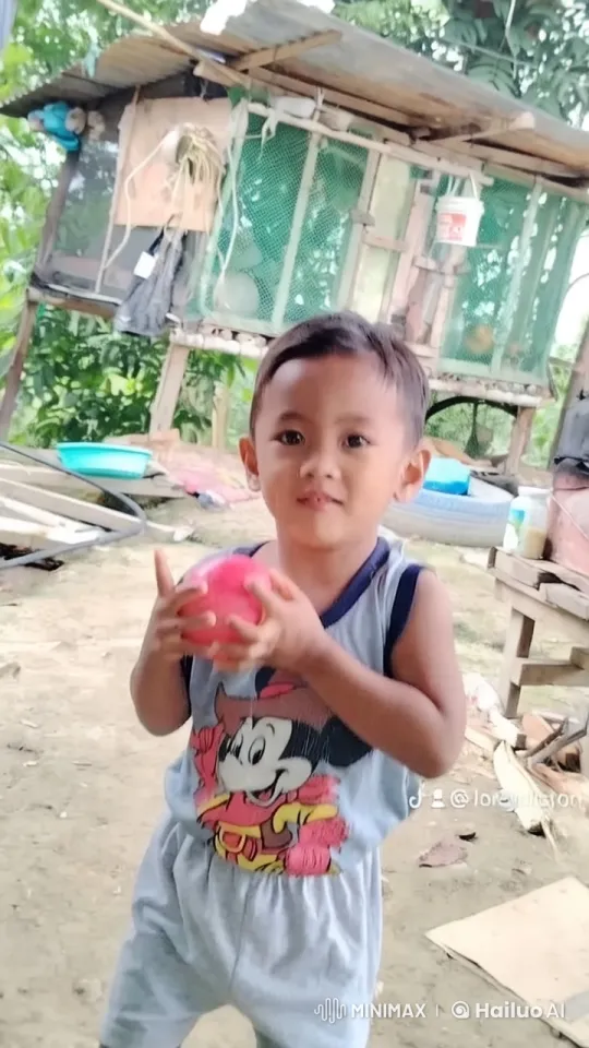 Child Playing with Ball in Rustic Outdoor Setting – AI Generated Video | Hailuo AI