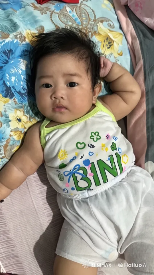 Baby on Colorful Bedspread in Serene Video – AI Generated Video | Hailuo AI