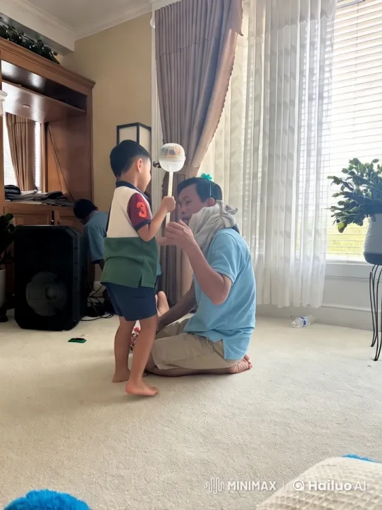 Young Boy and Man Playfully Spar in Bright Living Room – AI Generated Video | Hailuo AI