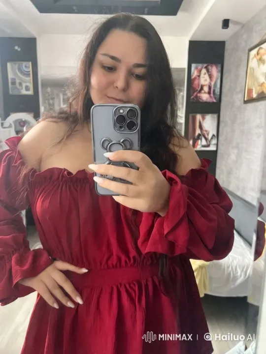 Woman in Red Dress Takes Mirror Selfie in Modern Bedroom – AI Generated Video | Hailuo AI