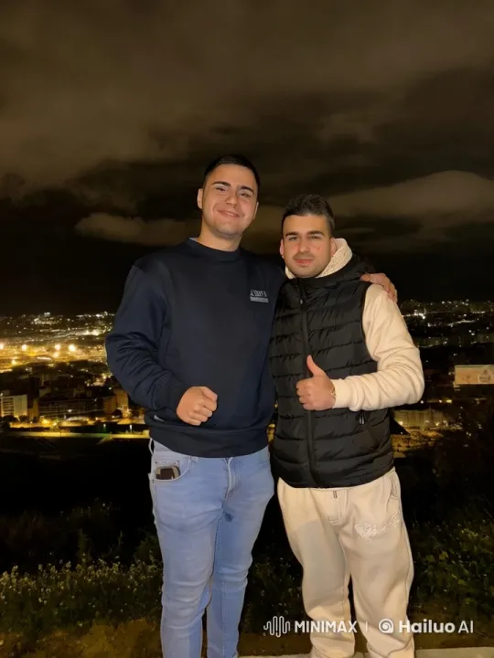 Intimate Embrace of Two Men Against City Lights – AI Generated Video | Hailuo AI