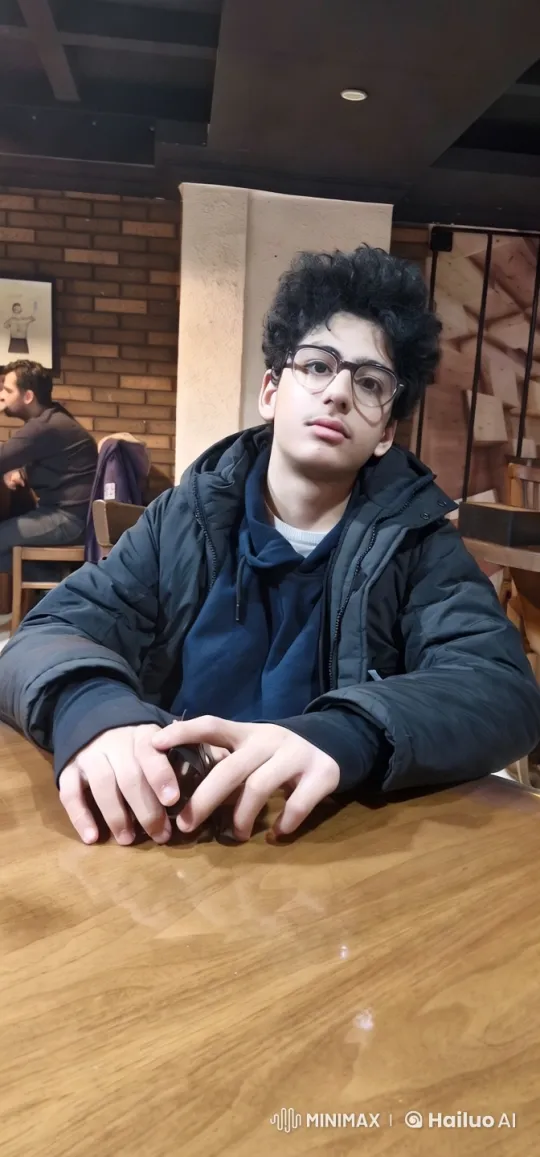 Young Man at Cozy Cafe Table – AI Generated Video | Hailuo AI