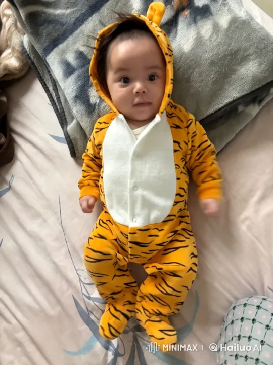 Baby in Tiger Costume Joyfully Plays on Cozy Bed – AI Generated Video | Hailuo AI
