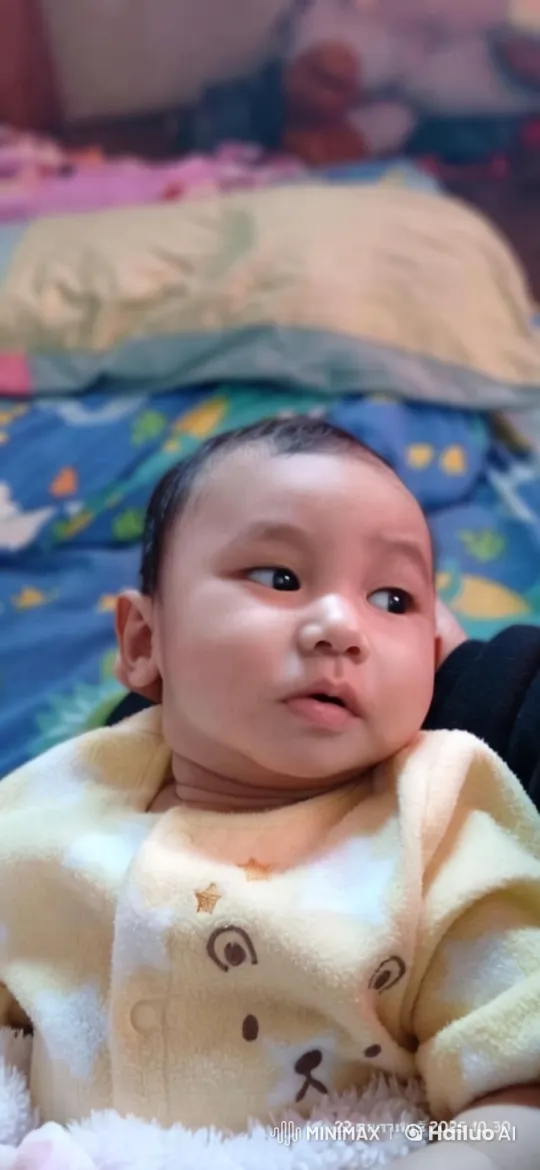 Baby Dancing in Onesie on Colorful Bedspread – AI Generated Video | Hailuo AI