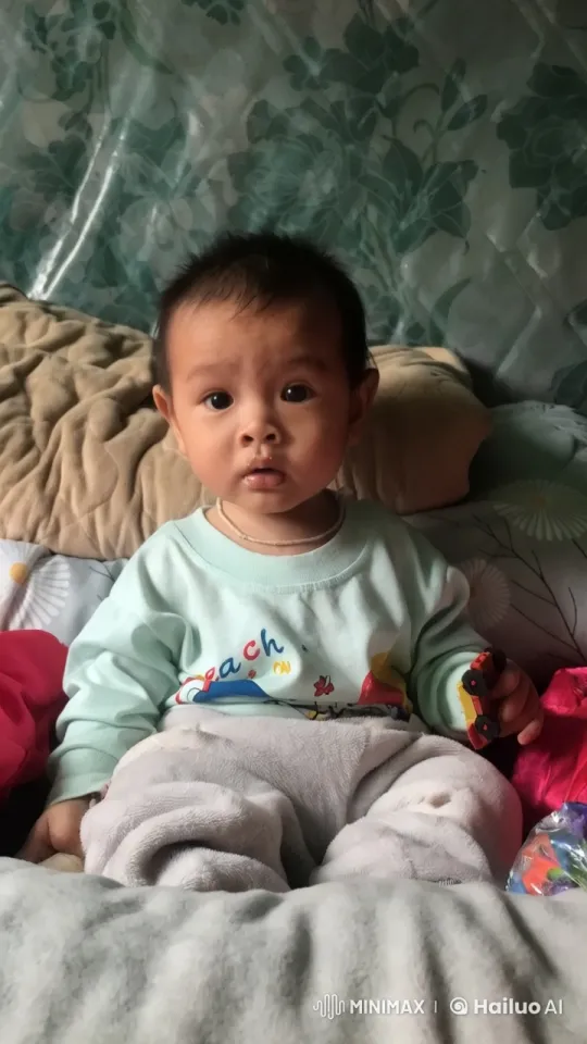 Cozy Playtime: Child with Toy Car in Comfortable Bed – AI Generated Video | Hailuo AI