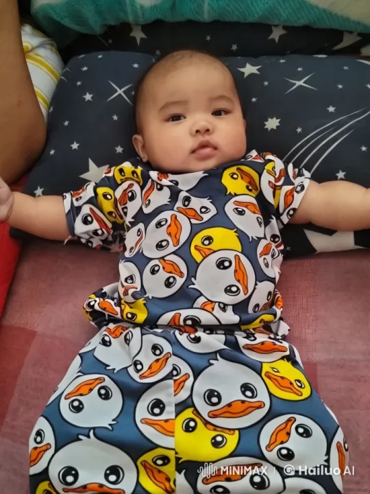 Baby in Colorful Duck Outfit on Star Pillow – AI Generated Video | Hailuo AI