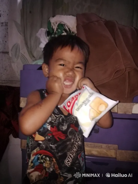 Young Boy Enjoying Snacks in Cozy Room – AI Generated Video | Hailuo AI