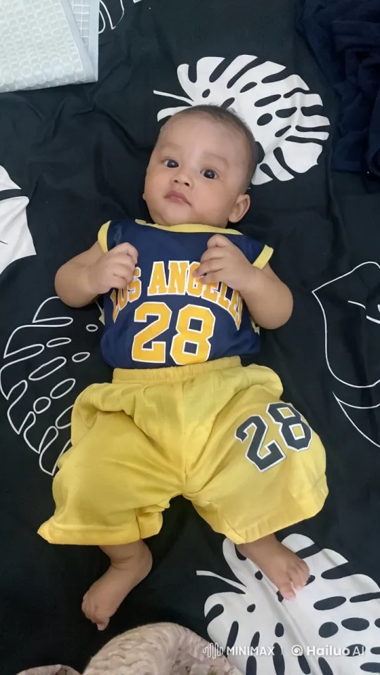 Baby Dancing in Sports Outfit on Patterned Bedspread – AI Generated Video | Hailuo AI