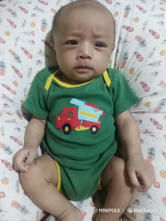 Baby in Green Onesie Wiggles Gently – AI Generated Video | Hailuo AI