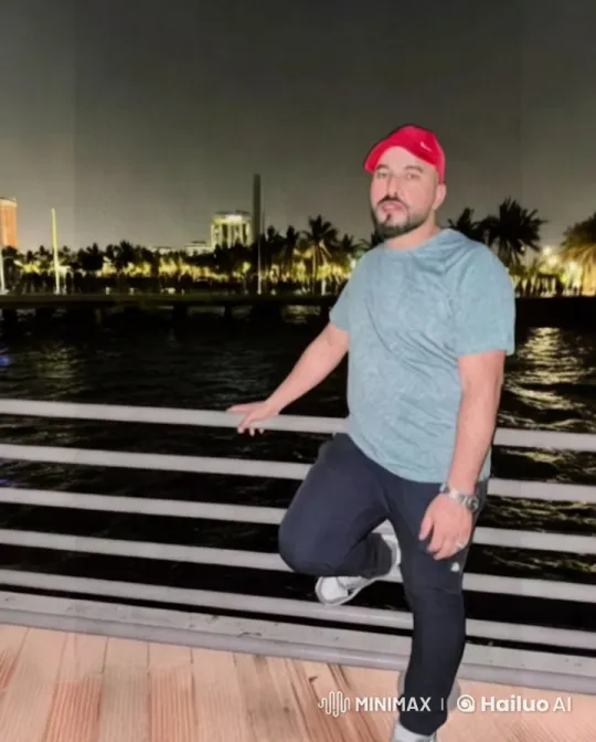 Night Scene: Man by Waterfront with City Lights – AI Generated Video | Hailuo AI