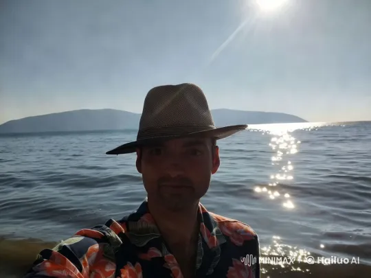 Beach Serenity: Person at Shoreline with Mountainous Horizon – AI Generated Video | Hailuo AI