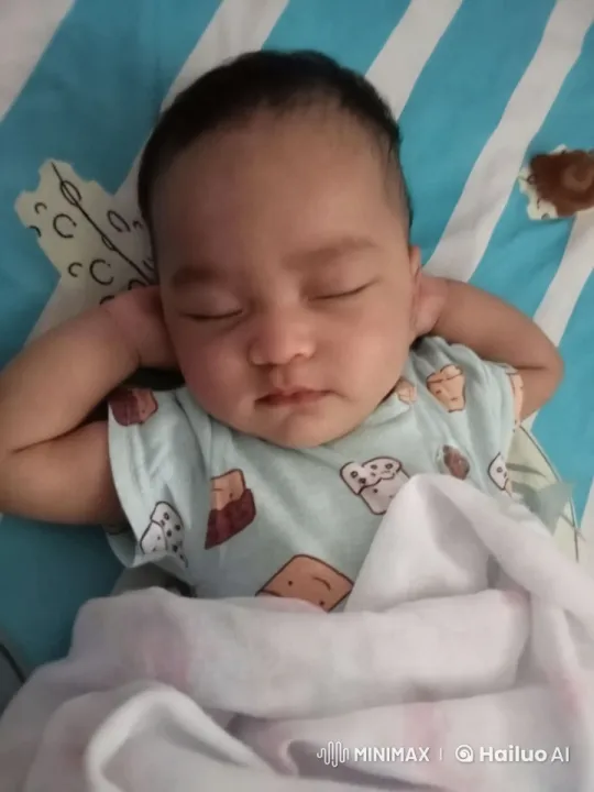 Baby Dances Playfully in Onesie on Bed – AI Generated Video | Hailuo AI