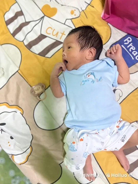 Baby Dancing and Playfully Punching in Colorful Bedspread Setting – AI Generated Video | Hailuo AI