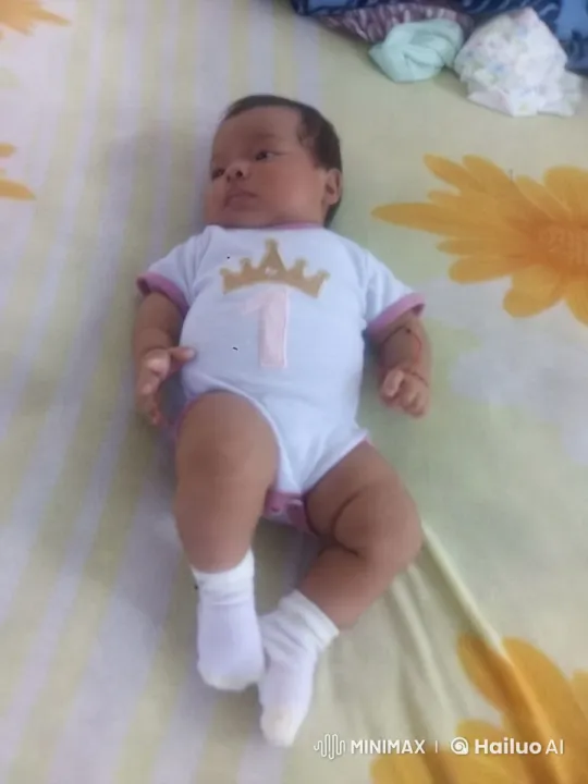 Baby in Onesie on Floral Bed with Soft Lighting – AI Generated Video | Hailuo AI