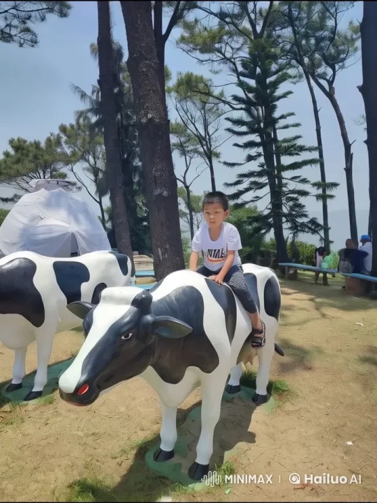 Child's Imaginative Battle on Cow Statue in Animated Park – AI Generated Video | Hailuo AI
