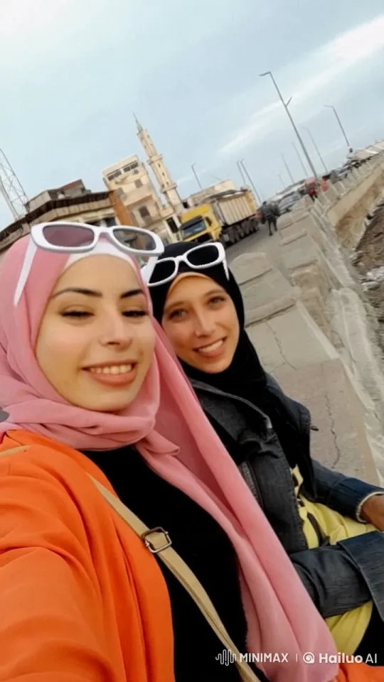 Two Individuals Transition from Stand to Lie in Cozy Urban Setting – AI Generated Video | Hailuo AI
