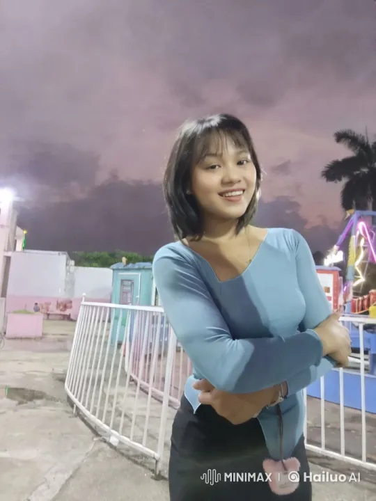 Young Woman in Amusement Park at Twilight – AI Generated Video | Hailuo AI