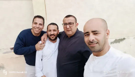 Group of Men Posing for Photo in Casual and Traditional Attire – AI Generated Video | Hailuo AI