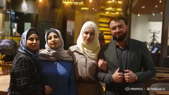 Cozy Cafe Group Portrait: Hijab-Wearing Women and Suit-Clad Man – AI Generated Video | Hailuo AI