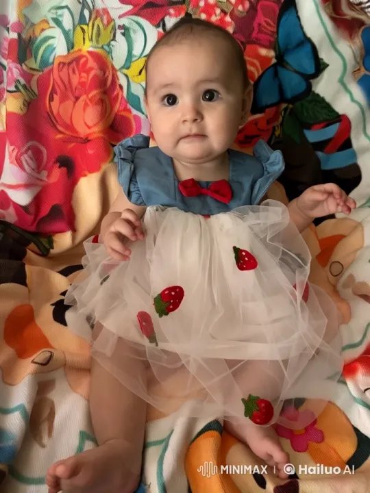 Baby in Charming Outfit Dances Joyfully on Colorful Blanket – AI Generated Video | Hailuo AI