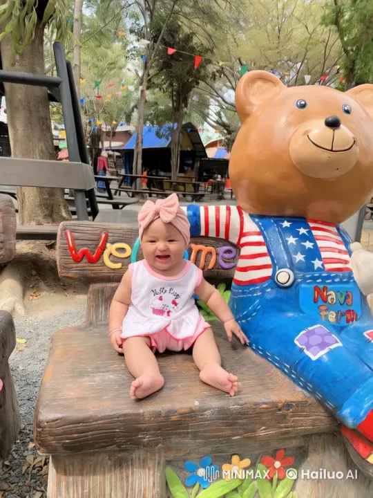 Child Dancing Joyfully at Park with Bear Statue – AI Generated Video | Hailuo AI