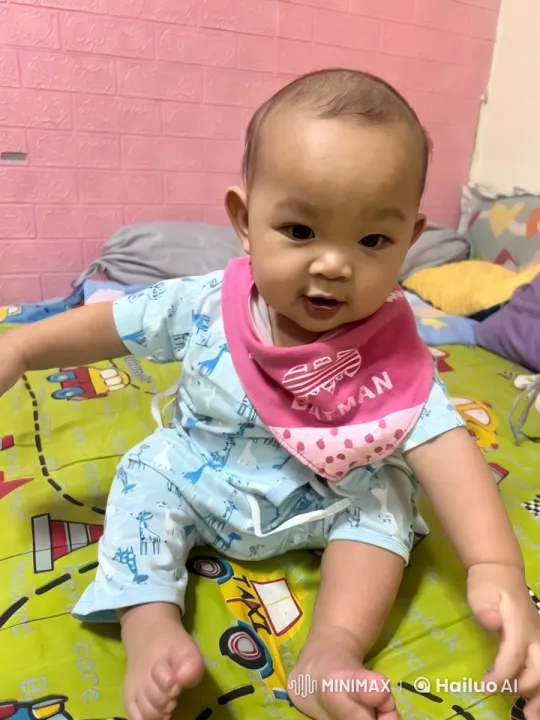Baby Dancing in Giraffe Pajamas on Colorful Bedspread – AI Generated Video | Hailuo AI