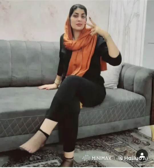 Modern Living Room with Graceful Woman in Black and Orange – AI Generated Video | Hailuo AI
