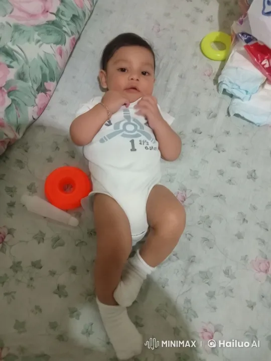 Baby on Floral Bed with Toys and Diapers – AI Generated Video | Hailuo AI