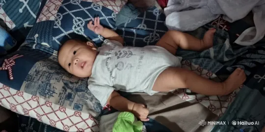 Baby's Joyful Dance on Colorful Bedspread – AI Generated Video | Hailuo AI