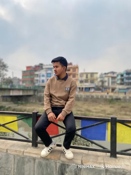 Young Man on Stone Edge Amidst Urban Landscape – AI Generated Video | Hailuo AI