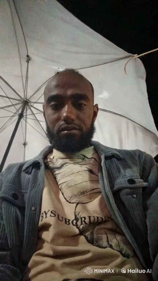 Contemplative Man Under White Umbrella at Night – AI Generated Video | Hailuo AI
