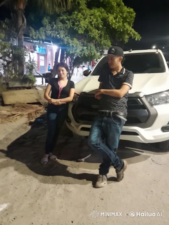 Couple by Car Amid Nighttime Gathering – AI Generated Video | Hailuo AI