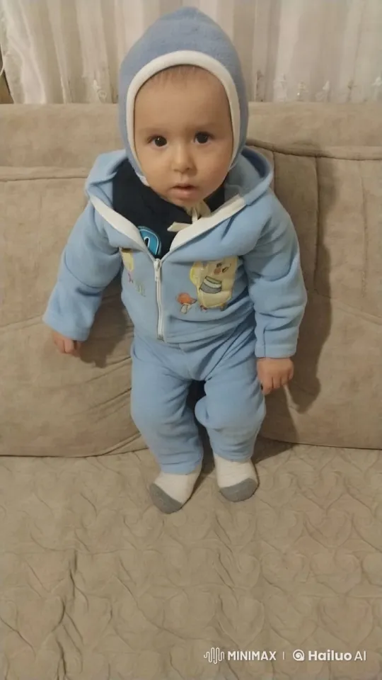 Baby in Blue Onesie on Beige Couch – AI Generated Video | Hailuo AI