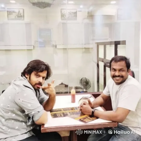 Two Men Chatting Over Food in Bright Room – AI Generated Video | Hailuo AI