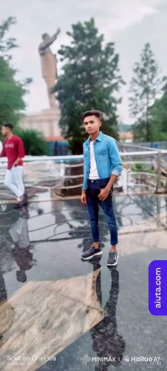 Young Man in Reflective Square with Statue Background – AI Generated Video | Hailuo AI