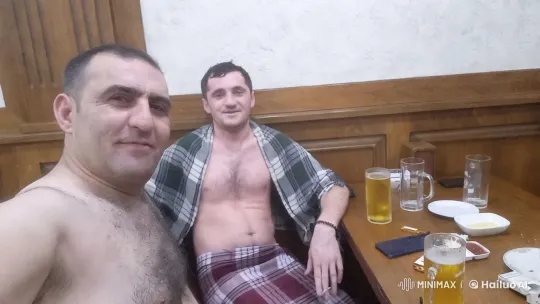 Cozy Room with Shirtless Men at Wooden Table – AI Generated Video | Hailuo AI