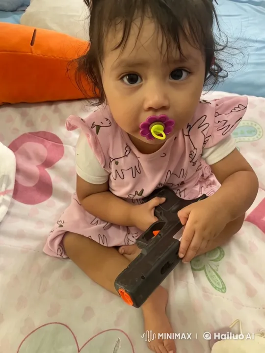 Child with Toy Gun Sways on Heart Blanket – AI Generated Video | Hailuo AI