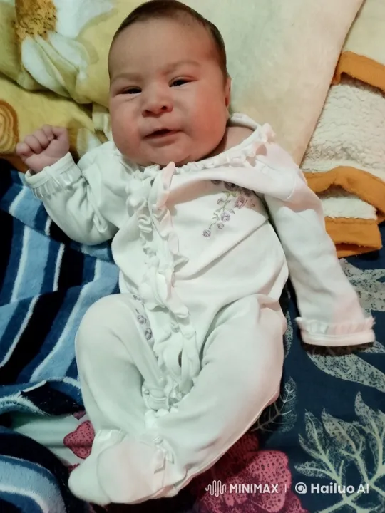 Baby in Floral Onesie on Cozy Bed – AI Generated Video | Hailuo AI