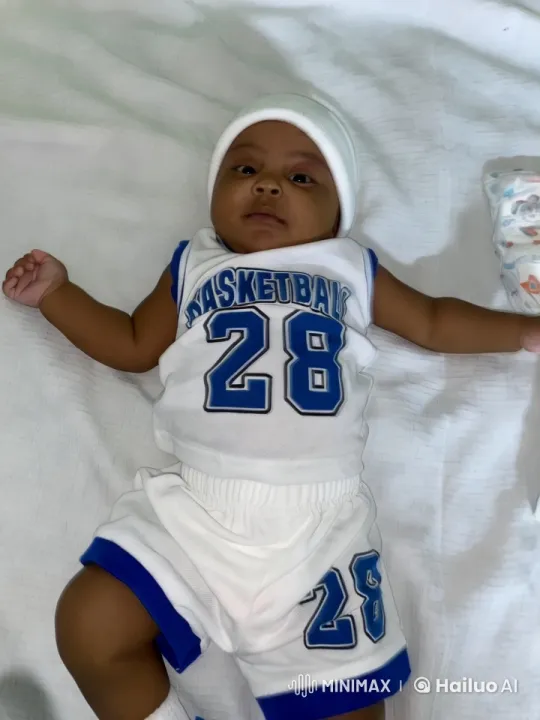 Baby in White Basketball Outfit on Clean Bed – AI Generated Video | Hailuo AI