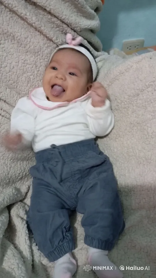 Baby in Soft Outfit on Beige Blanket with Gentle Movements – AI Generated Video | Hailuo AI