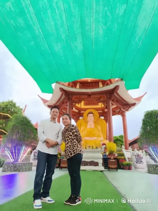 Couple in Serene Temple with Majestic Buddha Statue – AI Generated Video | Hailuo AI