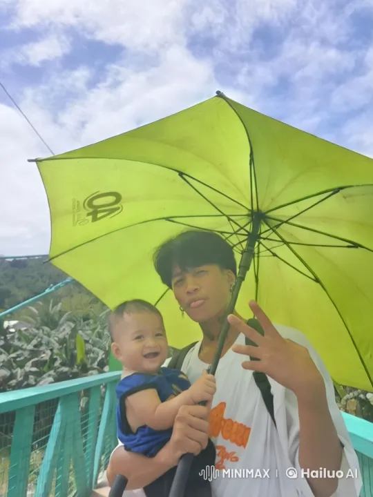 Joyful Duo Under Green Umbrella on Scenic Bridge – AI Generated Video | Hailuo AI