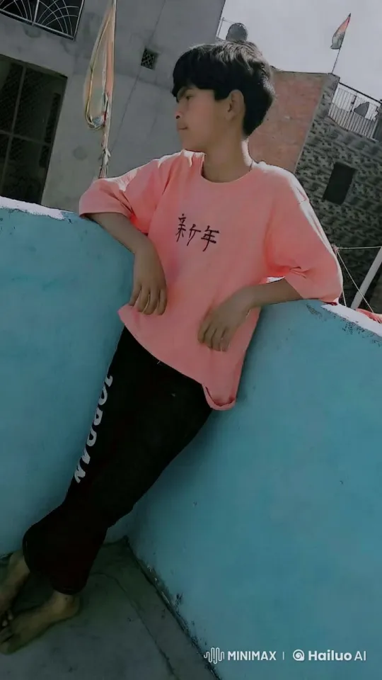 Young Boy on Rooftop Against Blue Wall – AI Generated Video | Hailuo AI