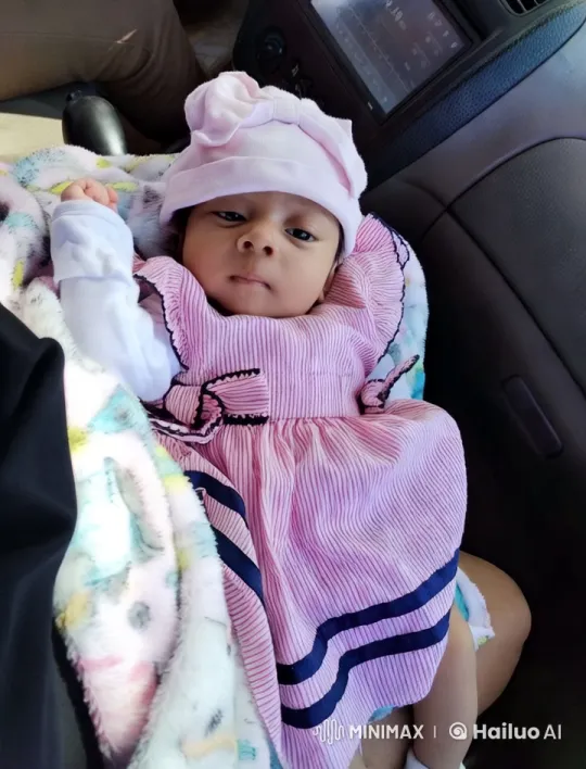 Baby in Striped Dress on Car Seat - Serene Close-Up – AI Generated Video | Hailuo AI