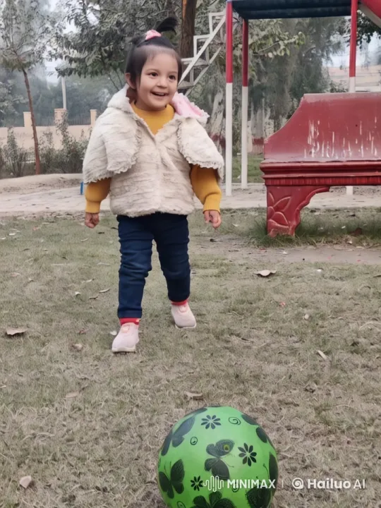 Child Approaches Ball in Playful Playground Setting – AI Generated Video | Hailuo AI