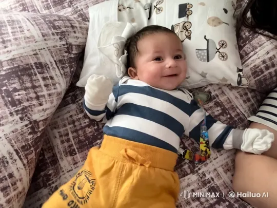 Happy Baby on Colorful Bed with Gentle Movements – AI Generated Video | Hailuo AI