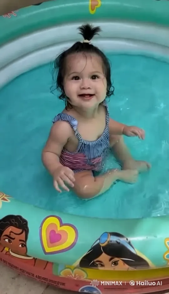Joyful Child Splashes in Colorful Inflatable Pool – AI Generated Video | Hailuo AI