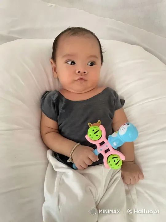 Baby Dancing Gently with Toy on White Cushion – AI Generated Video | Hailuo AI