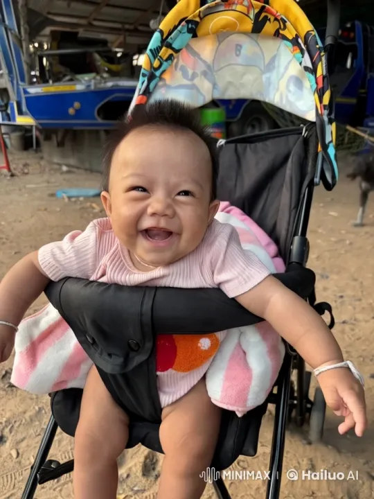 Joyful Baby in Colorful Stroller Amidst Outdoor Scenery – AI Generated Video | Hailuo AI
